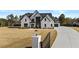 Charming two-story white brick home with black trim and a long driveway at 2485 Brooks Rd, Dacula, GA 30019