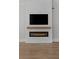 Modern fireplace with white brick surround, a sleek black firebox, and a simple wooden mantel at 2485 Brooks Rd, Dacula, GA 30019