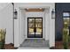 Elegant home entrance with black-framed glass doors and stylish lighting fixtures at 2485 Brooks Rd, Dacula, GA 30019
