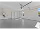 Three-car garage features epoxy floors, bead board walls, built-in shelves, and utility connections at 2485 Brooks Rd, Dacula, GA 30019