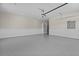 Garage boasts epoxy floors, bead board walls, storage shelves, and overhead door at 2485 Brooks Rd, Dacula, GA 30019