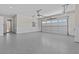 Three-car garage with epoxy flooring, two windows, bead board walls and access to interior at 2485 Brooks Rd, Dacula, GA 30019