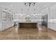 Bright, open kitchen features a large center island, stainless steel refrigerator, and abundant white cabinetry at 2485 Brooks Rd, Dacula, GA 30019