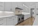 Bright kitchen showcases a professional-grade range and custom cabinetry, perfect for gourmet cooking at 2485 Brooks Rd, Dacula, GA 30019