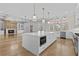 Open kitchen design showcases an expansive island, fireplace, and seamless flow to the living area at 2485 Brooks Rd, Dacula, GA 30019