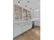 Bright kitchen with farmhouse sink, stainless steel dishwasher, white cabinetry, and backyard views at 2485 Brooks Rd, Dacula, GA 30019