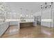 Bright, open kitchen features a large center island, stainless steel refrigerator, and abundant white cabinetry at 2485 Brooks Rd, Dacula, GA 30019