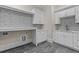 Well-organized laundry room with ample counter space, stylish tiling, and modern white cabinetry at 2485 Brooks Rd, Dacula, GA 30019