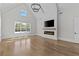 Open living room boasts a modern fireplace and large windows, providing ample natural light at 2485 Brooks Rd, Dacula, GA 30019