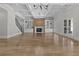 Light-filled living room with a fireplace, built-in shelving, and glass doors showcases sophisticated design at 2485 Brooks Rd, Dacula, GA 30019