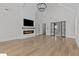 Inviting living room featuring a modern fireplace, vaulted ceilings, hardwood floors, and large windows at 2485 Brooks Rd, Dacula, GA 30019