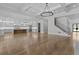 Spacious, open-concept living area leads to a modern kitchen and staircase with iron railing, all under coffered ceilings at 2485 Brooks Rd, Dacula, GA 30019