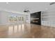 Open living room with hardwood floors, a modern fireplace, and natural light from large windows at 2485 Brooks Rd, Dacula, GA 30019