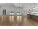 Expansive living space featuring multiple french doors leading outside and a kitchen area with sleek white cabinets at 2485 Brooks Rd, Dacula, GA 30019
