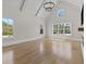 Spacious living room featuring vaulted ceilings, ample natural light, and gleaming hardwood floors at 2485 Brooks Rd, Dacula, GA 30019