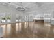 Expansive living area with coffered ceilings flowing into a modern kitchen, illuminated by natural light at 2485 Brooks Rd, Dacula, GA 30019