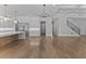 Open-concept living area with modern kitchen, breakfast bar, and staircase, offering seamless flow and stylish living at 2485 Brooks Rd, Dacula, GA 30019