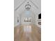 Spacious living room with vaulted ceiling, chandelier, and a fireplace with a TV mounted above at 2485 Brooks Rd, Dacula, GA 30019