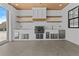 Outdoor kitchen on patio featuring stainless steel appliances, wood ceiling and white brick at 2485 Brooks Rd, Dacula, GA 30019