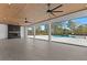 Large outdoor patio features a fireplace, ceiling fans, and a view of the sparkling swimming pool at 2485 Brooks Rd, Dacula, GA 30019