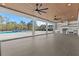 Spacious outdoor patio with a full kitchen, wood ceiling, ceiling fans, and views of a swimming pool at 2485 Brooks Rd, Dacula, GA 30019