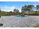 Outdoor pool with water feature and paver surround with a privacy fence and trees in the background at 2485 Brooks Rd, Dacula, GA 30019