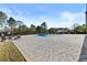 A backyard pool with surrounding stone pavers, a seating area, and perimeter privacy fence at 2485 Brooks Rd, Dacula, GA 30019