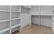 Spacious walk-in closet with custom shelving and hardwood floors at 2485 Brooks Rd, Dacula, GA 30019