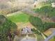 Stunning aerial view of the clubhouse nestled amongst lush greenery near the winding river at 304 Gilmer Ct, Canton, GA 30115