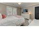 Comfortable bedroom with a cozy bed, soft carpet, and a window for natural light, creating a relaxing retreat at 304 Gilmer Ct, Canton, GA 30115