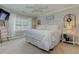 Cozy bedroom with plush carpeting, white bedding, and plenty of natural light from the large windows at 304 Gilmer Ct, Canton, GA 30115