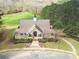 An aerial view of the clubhouse, featuring rocking chair front porch and manicured landscaping at 304 Gilmer Ct, Canton, GA 30115
