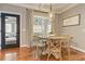 Dining room features a modern light fixture, round wood table, and a glass patio door at 304 Gilmer Ct, Canton, GA 30115