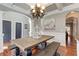 Traditional dining room with wood floors, coffered ceiling, and rustic wood dining table at 304 Gilmer Ct, Canton, GA 30115