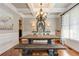 Dining room featuring coffered ceilings, chandelier, large windows, and wainscoting detail at 304 Gilmer Ct, Canton, GA 30115