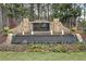 Stone community entrance featuring an attractive water feature and lovely landscaping at 304 Gilmer Ct, Canton, GA 30115