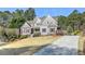 Beautifully landscaped lawn, long driveway, and a charming exterior create the perfect curb appeal at 304 Gilmer Ct, Canton, GA 30115