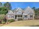 Beautiful two-story home with stone accents, landscaped lawn, and inviting front porch at 304 Gilmer Ct, Canton, GA 30115