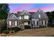 Charming two-story home with stone accents, beautiful landscaping, and a welcoming front porch at 304 Gilmer Ct, Canton, GA 30115