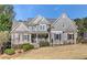 Charming two-story home with stone accents, beautiful landscaping, and a welcoming front porch at 304 Gilmer Ct, Canton, GA 30115