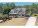 Gray two-story home featuring a stone accent exterior, well-manicured lawn, and inviting driveway at 304 Gilmer Ct, Canton, GA 30115