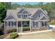 Charming two-story home with a stone and shingle exterior and manicured lawn at 304 Gilmer Ct, Canton, GA 30115