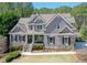 Beautiful two-story house with gray siding, a welcoming front porch and manicured landscaping at 304 Gilmer Ct, Canton, GA 30115