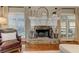 Stone fireplace with large windows and decorative mantel in a cozy living room at 304 Gilmer Ct, Canton, GA 30115