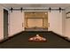 Game room area featuring a pool table in front of white barn doors and a projector for an at-home movie theater at 304 Gilmer Ct, Canton, GA 30115