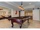 Spacious game room featuring a pool table, hardwood floors, and access to a separate seating area with sliding barn doors at 304 Gilmer Ct, Canton, GA 30115