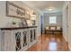 Inviting hallway with hardwood floors, decorative cabinet, and a bench, creating a warm and welcoming atmosphere at 304 Gilmer Ct, Canton, GA 30115