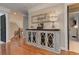 Charming hallway featuring hardwood flooring, a decorative cabinet, and access to other rooms in the home at 304 Gilmer Ct, Canton, GA 30115