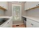 Functional laundry room with ample storage, counter space, and a window providing natural light at 304 Gilmer Ct, Canton, GA 30115