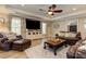 Spacious living room with leather furniture, a ceiling fan, and wood-style flooring at 304 Gilmer Ct, Canton, GA 30115